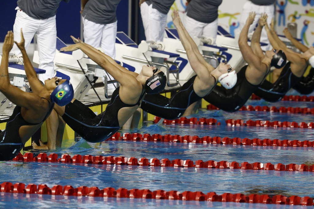 Jul 17, 2015; Toronto, Ontario, CAN; Olivia Smoliga of the United States dives in at the start of the women's 100m backstroke final the 2015 Pan Am Games at Pan Am Aquatics UTS Centre and Field House. Mandatory Credit: Rob Schumacher-USA TODAY Sports