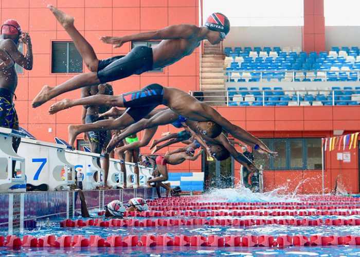 Giovanni going off the block at a swim meet